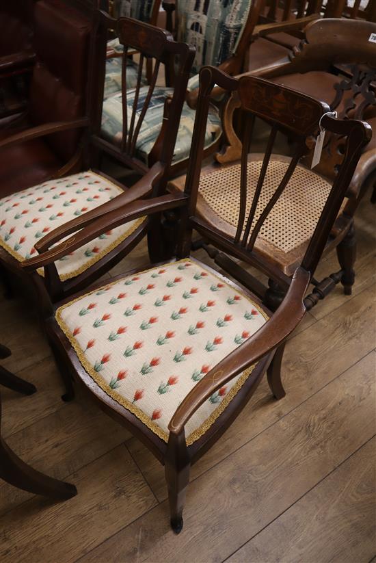 A pair of Edwardian inlaid elbow chairs